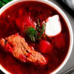 This Classic Red Borscht with Ribs (beet soup) is a traditional Ukrainian dish, loaded with vegetables such as potatoes, beet, cabbage, carrots and more. This hearty soup is very popular and loved by so many all around the world. | olgainthekitchen.com