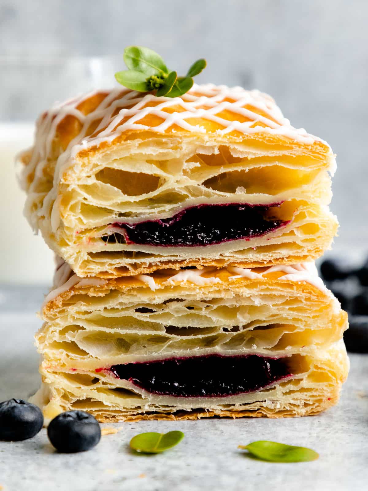 These Homemade Jam Filled Toaster Strudels are like mini flaky pies filled with homemade blackberry jam and topped with sweet vanilla glaze. #puffpastry #toasterstrudel #olgainthekitchen #pepperidgefarm #pie #pastry #jam #dessert #breakfast