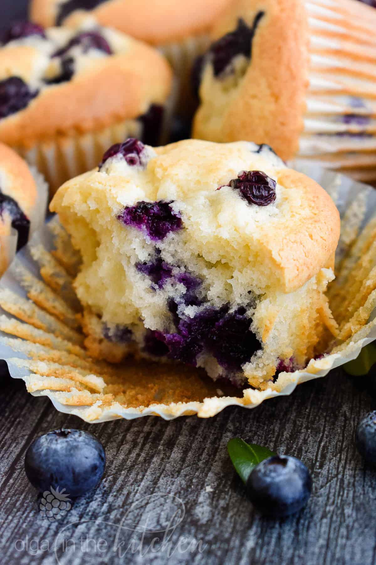 These Sour Cream Blueberry Muffins are bursting with sweet and fresh blueberry flavor. They are soft and perfectly moist on the inside with perfectly golden brown top. #blueberrymuffins #muffins #olgainthekitchen #breakfast #dessert #summer #bread #easyrecipe