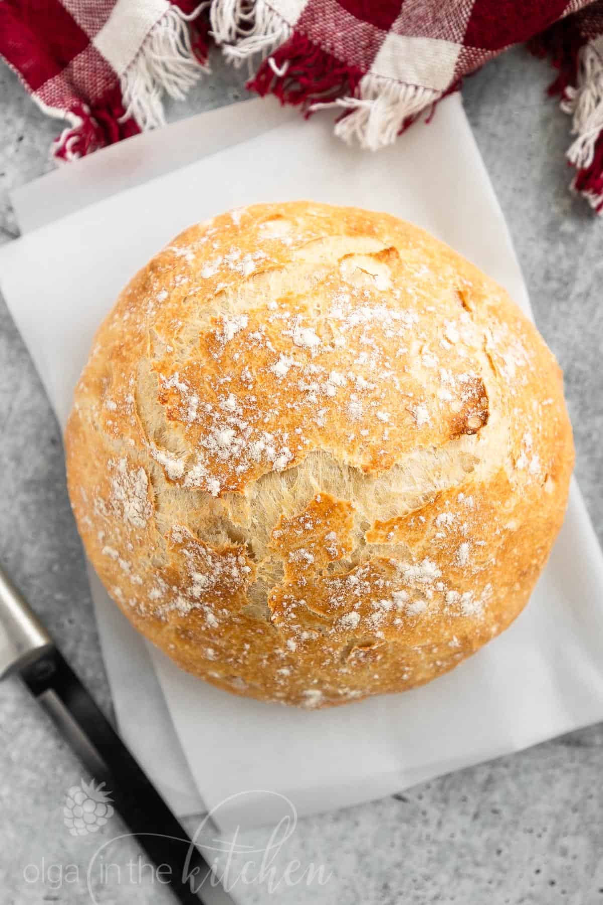 This easy No-Knead Bread loaf has a deliciously crisp crust and a soft spongy center. It’s the perfect blend of soft and chewy. With only 4 ingredients (flour, salt, yeast and water), you can make a bakery-quality, scrumptious loaf of homemade bread. #nokneadbread #bread #olgainthekitchen #easyrecipe #recipes #rusticbread