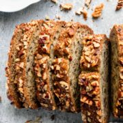 This super-moist Banana Nut Bread Recipe is loaded with bananas, pecans and incredibly soft crumb. It is simple to make and a great way to use those overripe bananas. This moist banana nut bread is so easy and makes a great breakfast on-the-go. #banananutbread #moistbananabread #bananabread #banananutbreadrecipe #bananabreadrecipe #nutbread #olgainthekitchen
