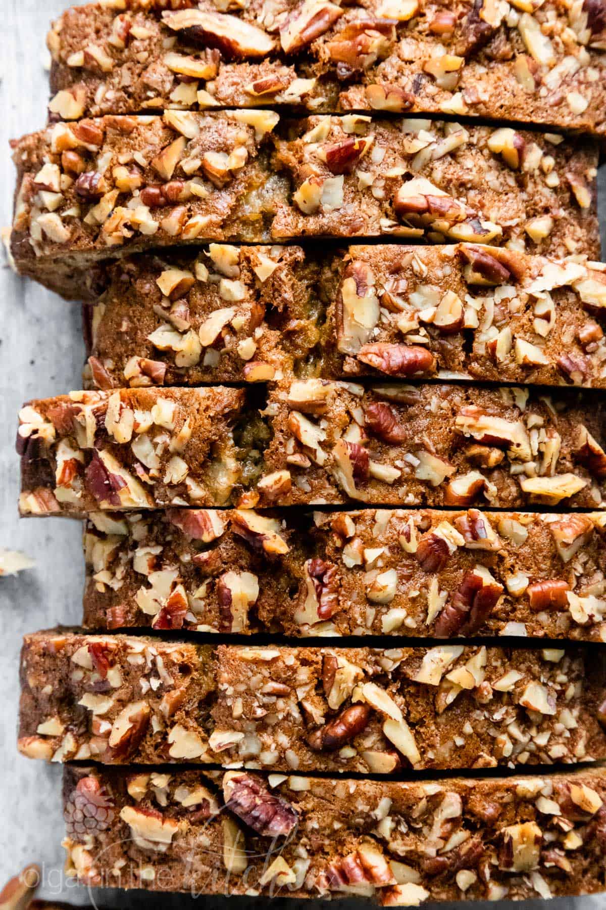 This super-moist Banana Nut Bread Recipe is loaded with bananas, pecans and incredibly soft crumb. It is simple to make and a great way to use those overripe bananas. This moist banana nut bread is so easy and makes a great breakfast on-the-go. #banananutbread #moistbananabread #bananabread #banananutbreadrecipe #bananabreadrecipe #nutbread #olgainthekitchen
