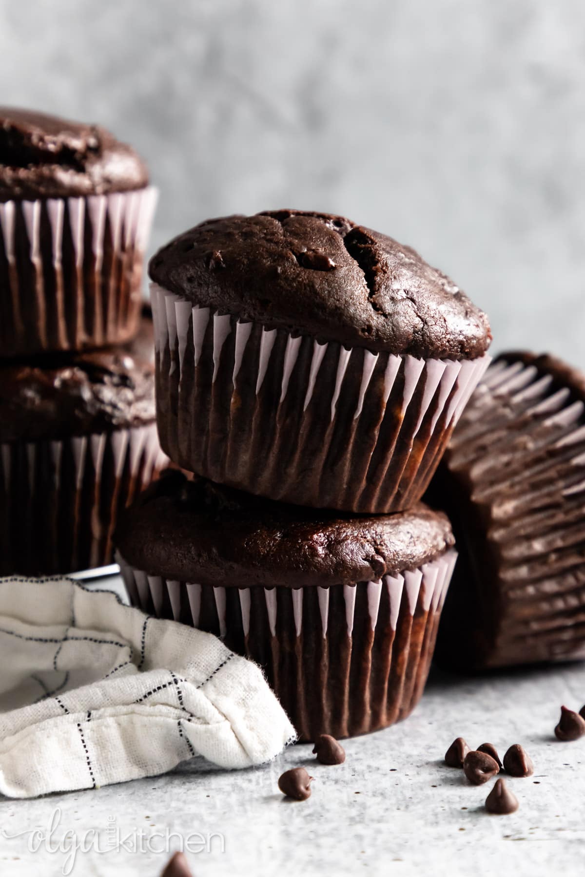 These Double Chocolate Banana Muffins are so easy to make, bursting with rich chocolate flavor and loaded with chocolate chips. They are soft and perfectly moist. #olgainthekitchen #bananamuffins #chocolatemuffins #muffins #chocolatebananamuffins #breakfast