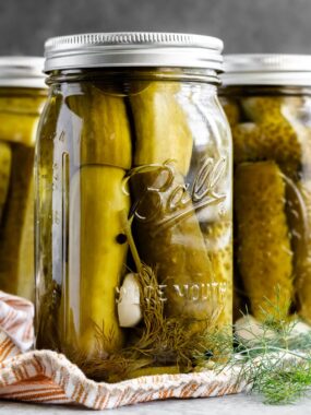 These easy homemade dill pickles are perfectly crisp, tangy and refreshing. They are seasoned with just the right amount of dill and garlic. Whether you’ll serve them with hot dogs, hamburgers or simply enjoy as a snack, they will be good for up to a year in your pantry.